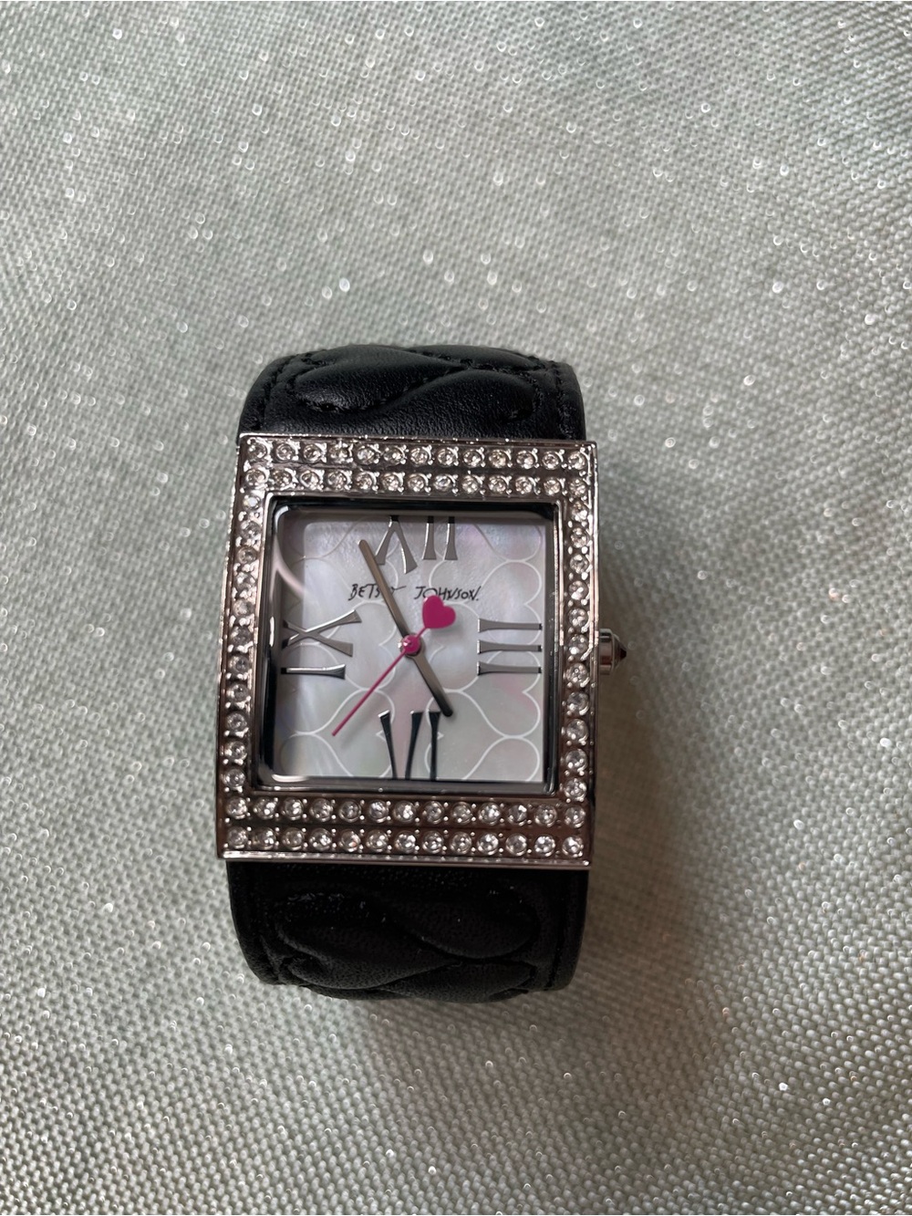 Betsy Johnson cuff style watch. Quilted black band. Stainless steel accents.